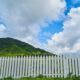 white fence with clouds and blue sky