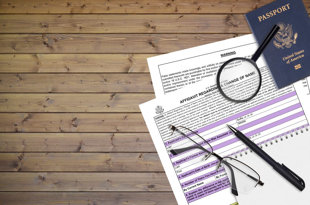 Department of State form DS60 Affidavit Regarding a change of name lies on table and ready to fill. Paperwork during operations with US Passport concept