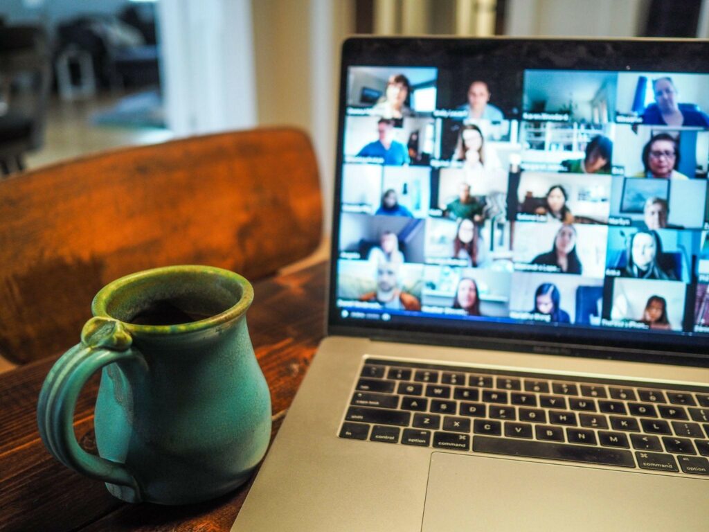 A desk with a laptop in a video call, which Darren and Mike can coach salespeople through