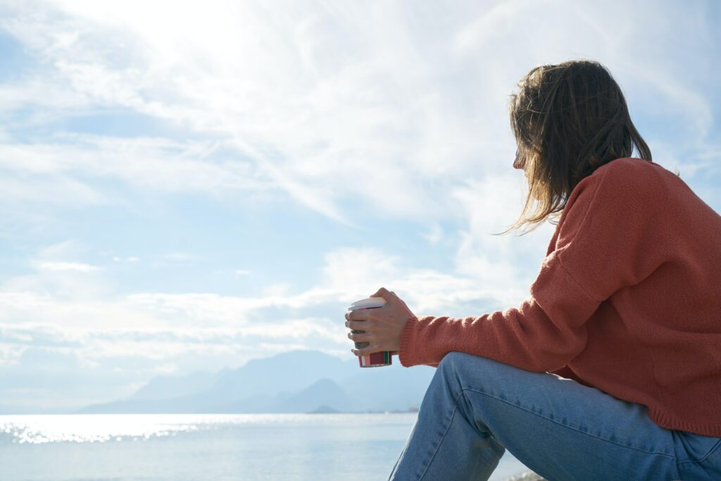 A girl sitting next to water