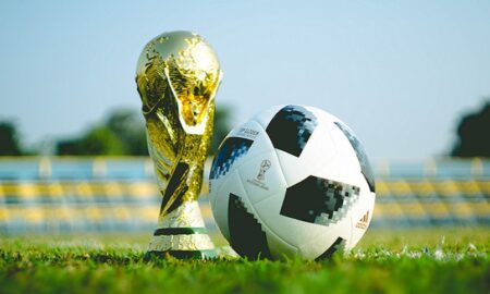 World cup and football token on a pitch