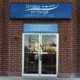 Exterior view of Smiles on Yonge Orthodontics in Richmond Hill, featuring the clinic's entrance and blue storefront signage.
