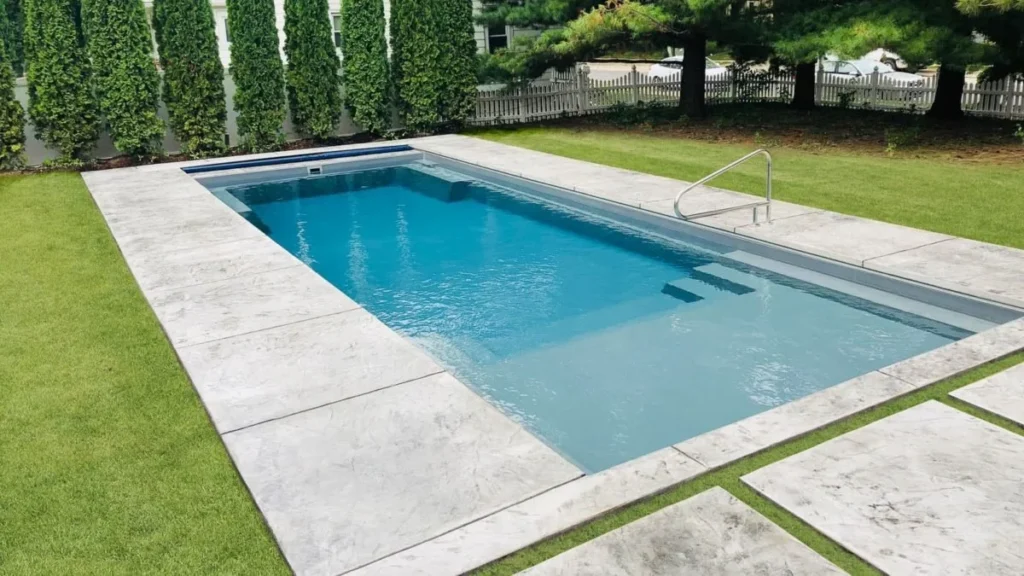 engineers and technicians installing a fiberglass pool in a modern Dayton backyard