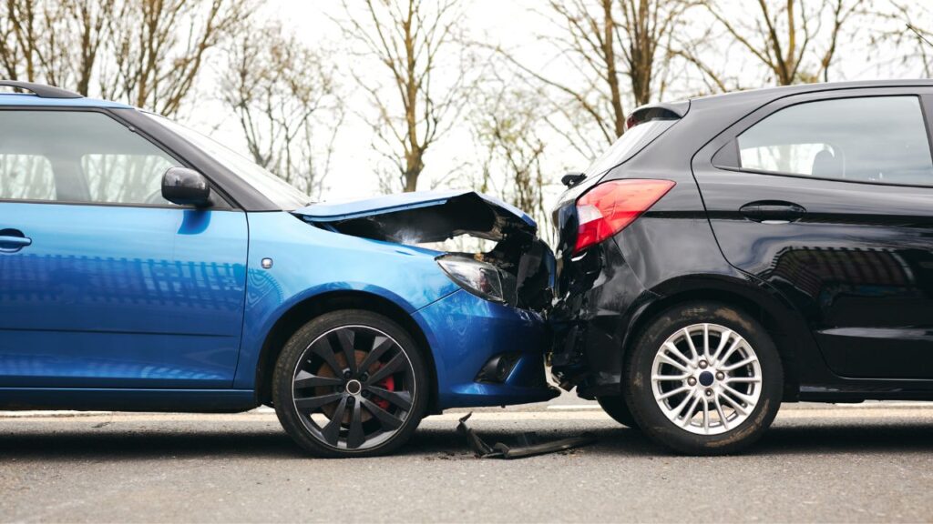Damaged car on the road with claim documents representing Nassau car accident recovery