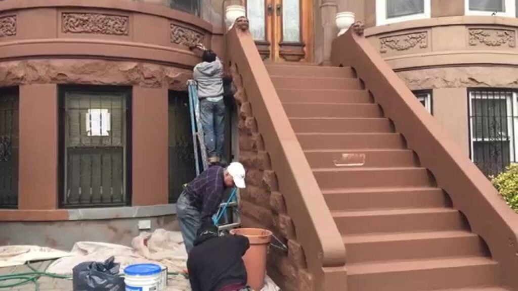 Brownstone building exterior showing a restored stoop and classic architectural details