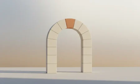 Minimalist stone arch with a single contrasting keystone, symbolizing a pivotal initiative in building strong company culture.