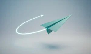 Teal paper airplane sharply changing direction with a glowing arc on a soft gray-blue background, symbolizing a quick strategic pivot.