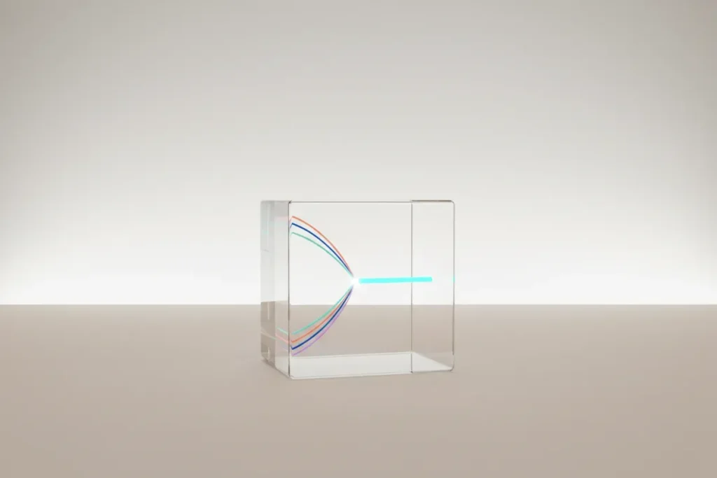 Transparent glass cube with colored light threads merging into one, symbolizing streamlined startup communication.