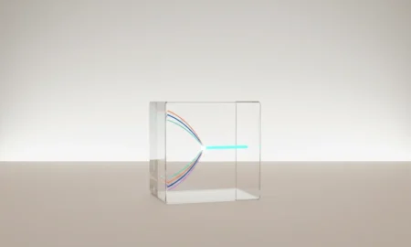 Transparent glass cube with colored light threads merging into one, symbolizing streamlined startup communication.