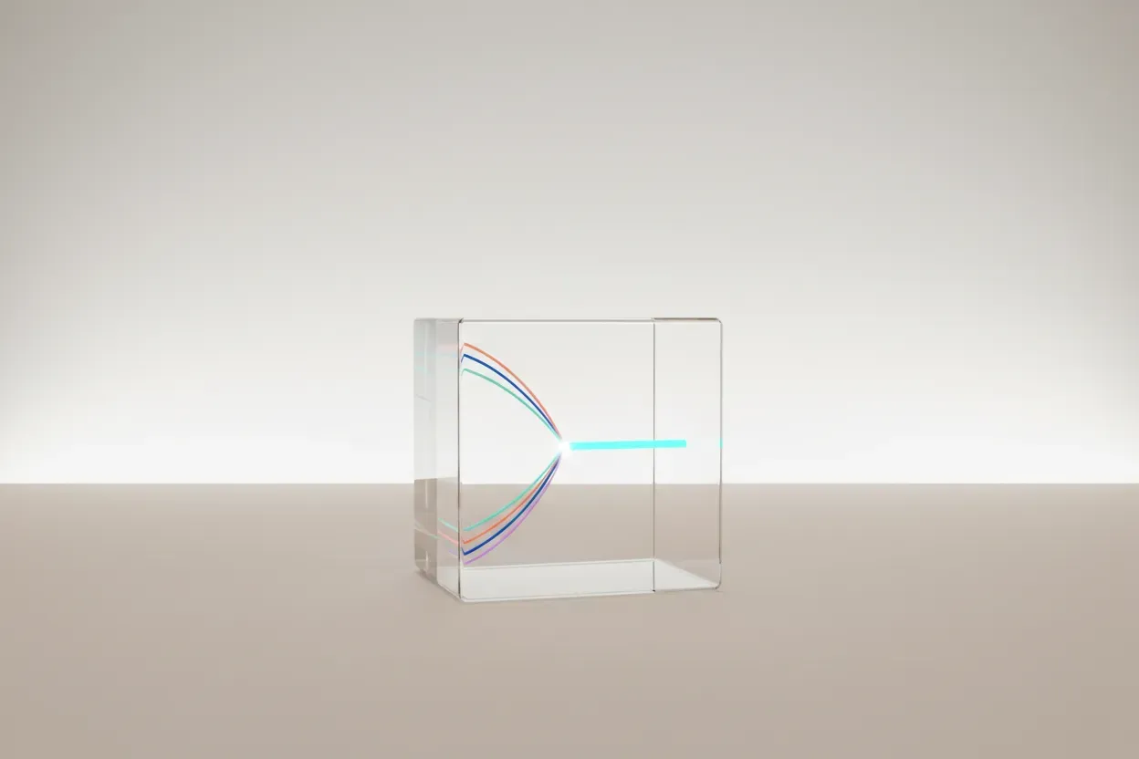 Transparent glass cube with colored light threads merging into one, symbolizing streamlined startup communication.