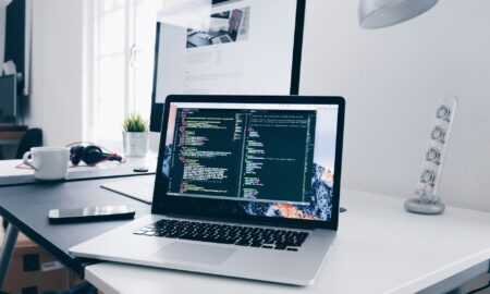Professional remote work workspace featuring ergonomic desk, USB-C monitor, and smart office accessories