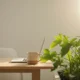 A calm workspace blends with an indoor garden, symbolizing seamless work-life integration and a mindful daily transition.