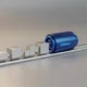 Blue technology accelerator propelling connected workflow blocks along a streamlined track on a neutral background.