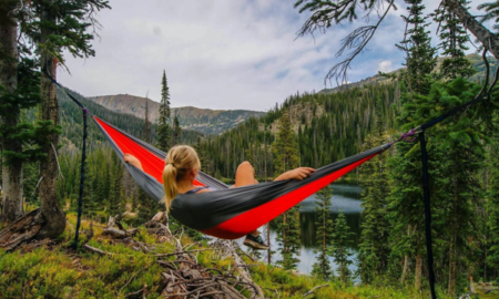 Woman traveling alone with luggage while exploring a scenic destination, representing the growing trend of solo female travel in 2026.