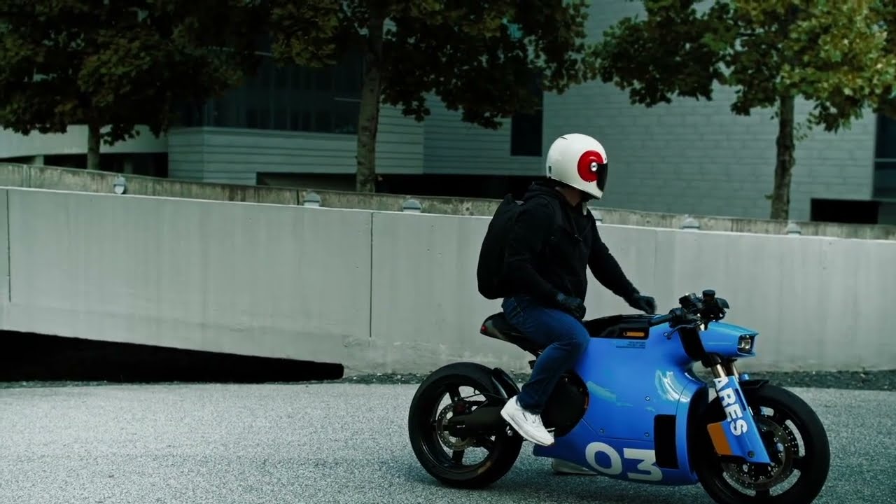 Rider seated on a Real Motors Project ARES electric motorcycle.