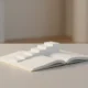Open notebook with pages forming upward steps, symbolizing continuous learning and entrepreneurial growth