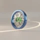A polished blue and green flywheel gaining momentum, symbolizing organizational alignment and buy-in for faster change.