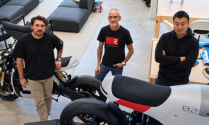 Three members of the Real Motors team alongside Project ARES motorcycles.