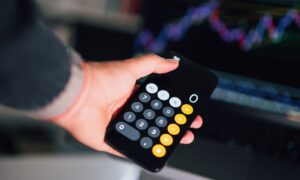 Concerned professional reviewing financial data on multiple screens showing cryptocurrency and digital transaction charts
