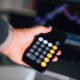 Concerned professional reviewing financial data on multiple screens showing cryptocurrency and digital transaction charts