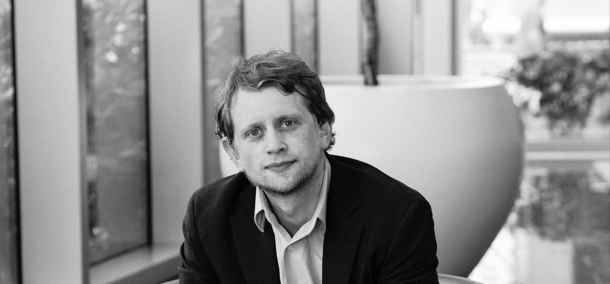 Portrait of Josh Silverbauer seated in modern office