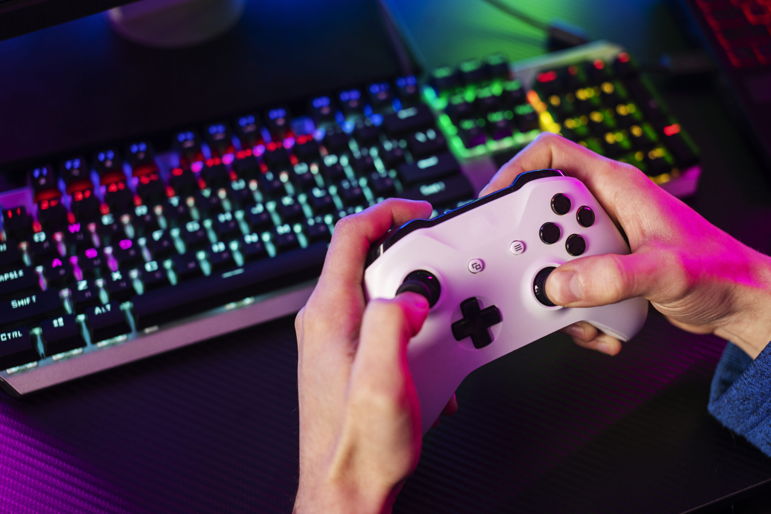 Gaming keyboard and controller representing online gaming account security, password protection, and cybersecurity measures to prevent phishing attacks and data breaches.