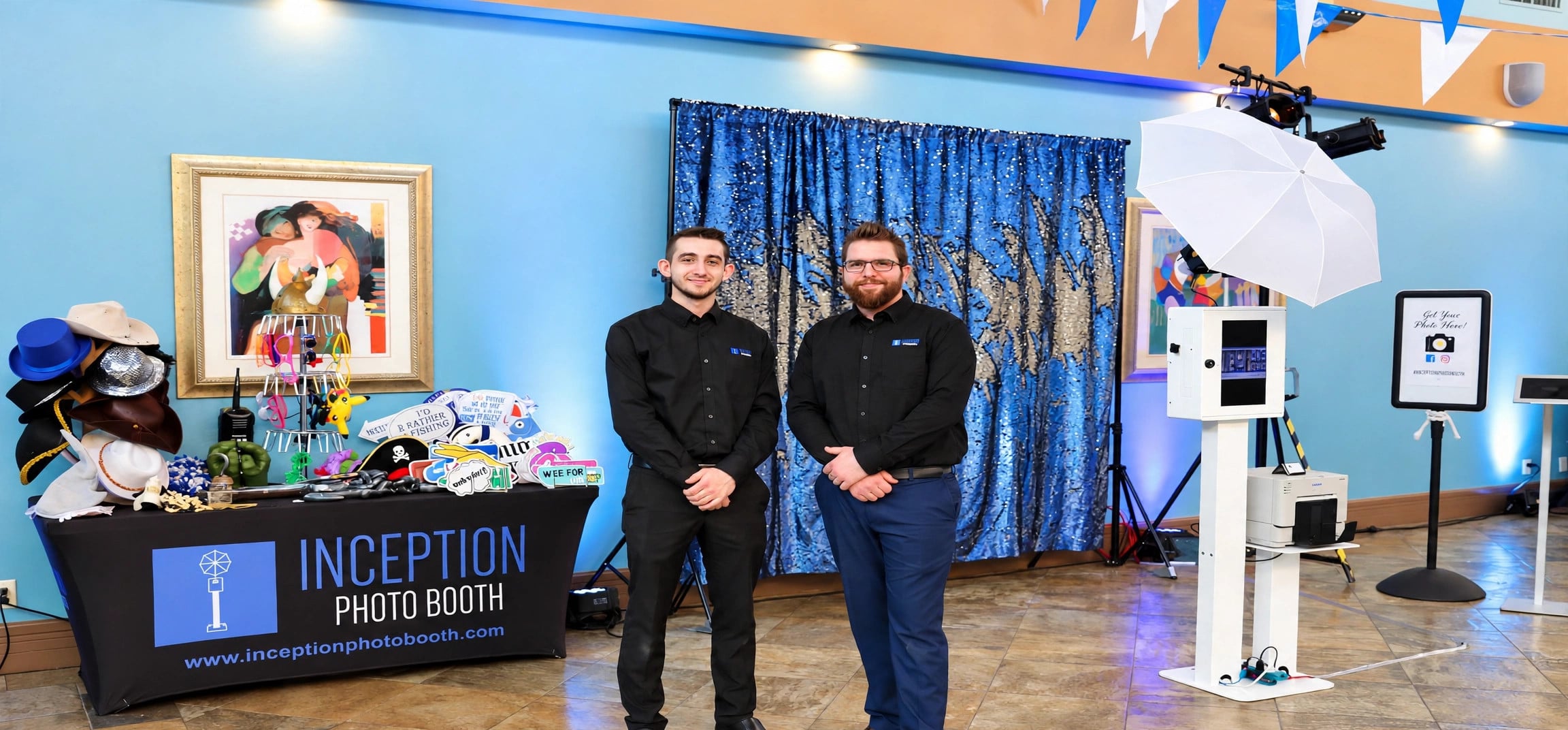 Inception Photo Booth event setup with attendants, props table and photo booth equipment