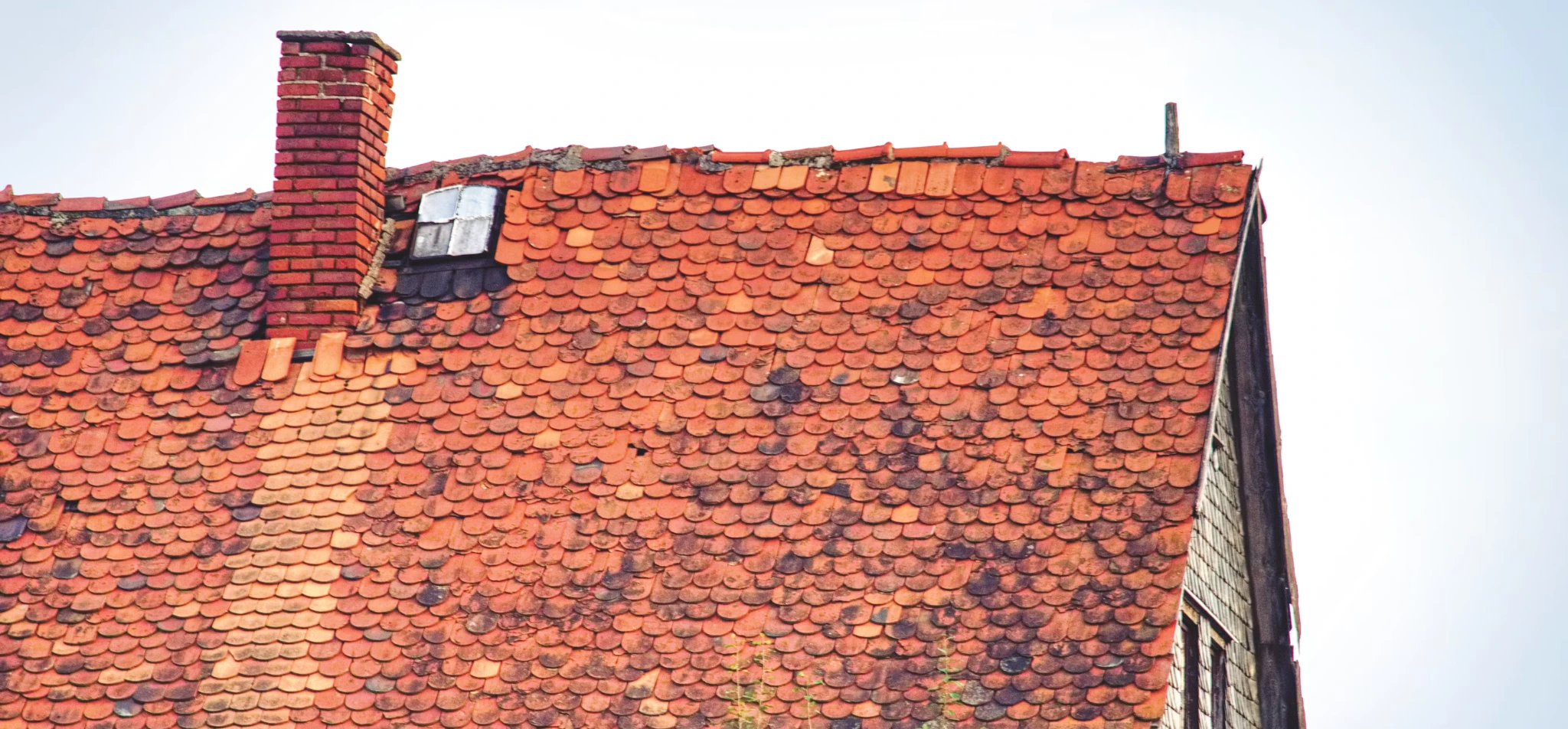Weathered clay tile roof showing dry-climate wear
