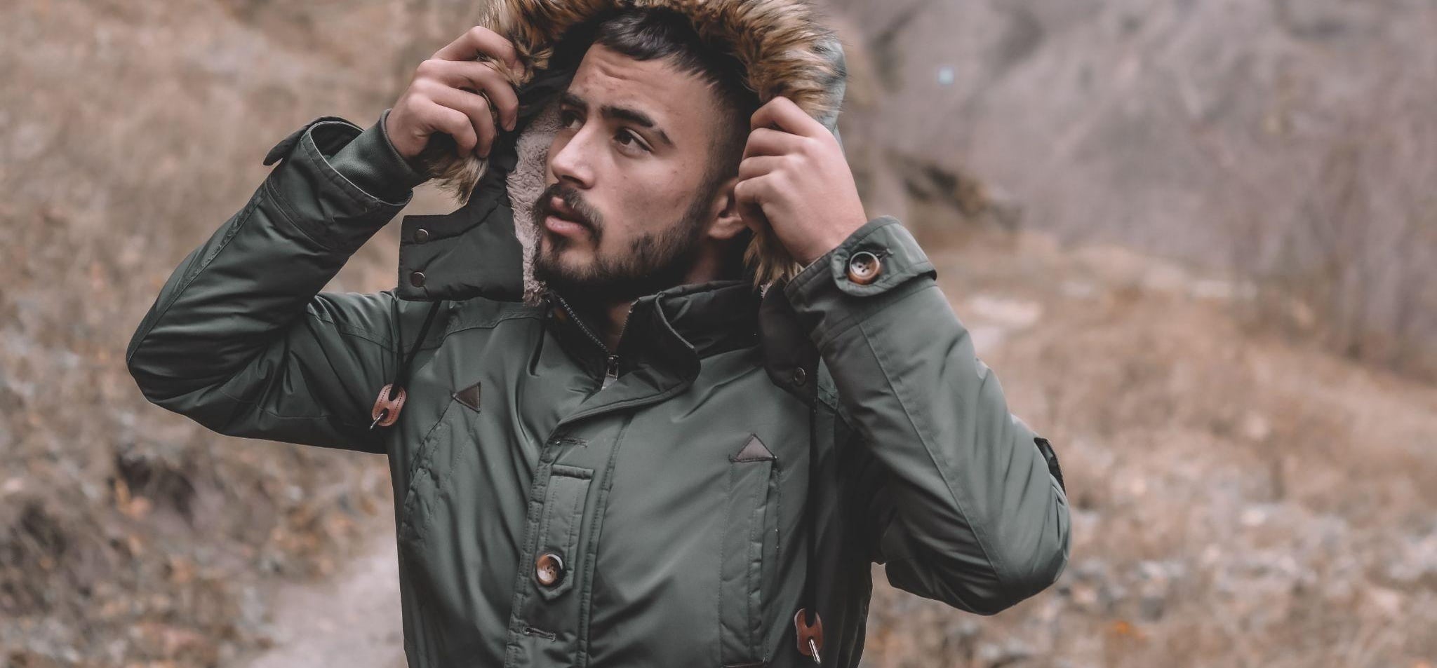 Man wearing green parka statement outerwear streetwear